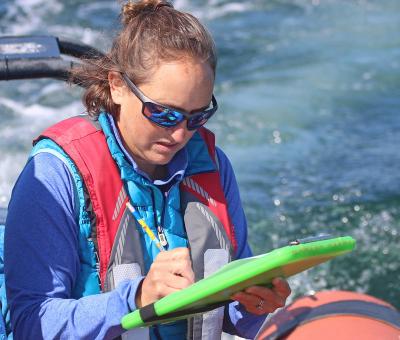 Leigh Torres takes notes on the whales she spots off the Oregon coast. 
