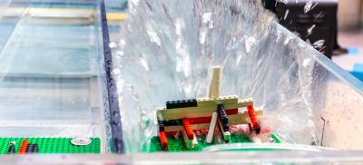 Water crashed against a Lego structure in the tsunami wave tank