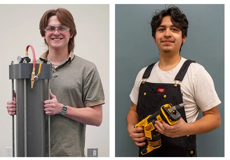 Two young people hold up a device and smile.