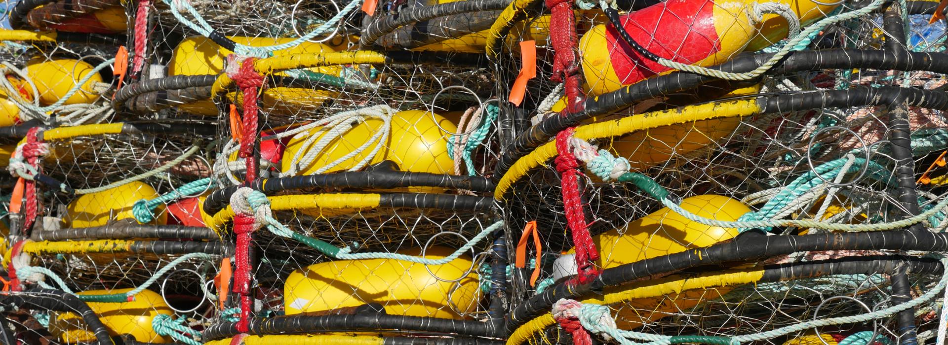 Crab pots are stacked on a boat.
