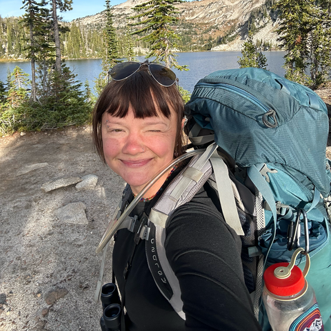 A person smiles at the camera. 